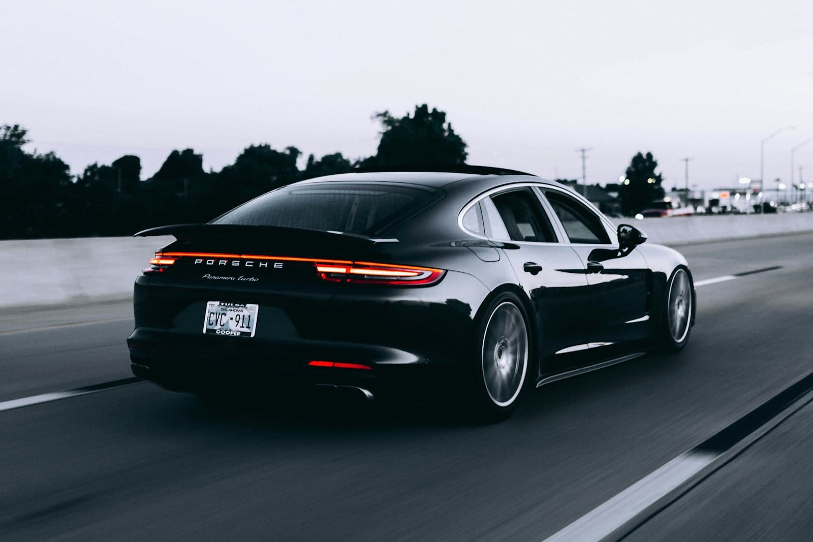 Luxury sports car on a dramatic mountain road at sunset